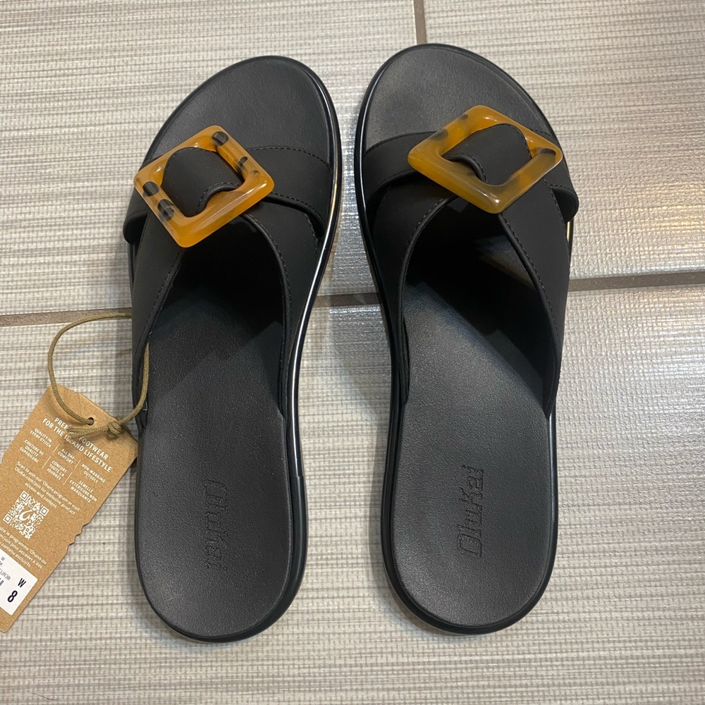 OluKai Black Slide Sandals with Amber Tortoiseshell Buckles